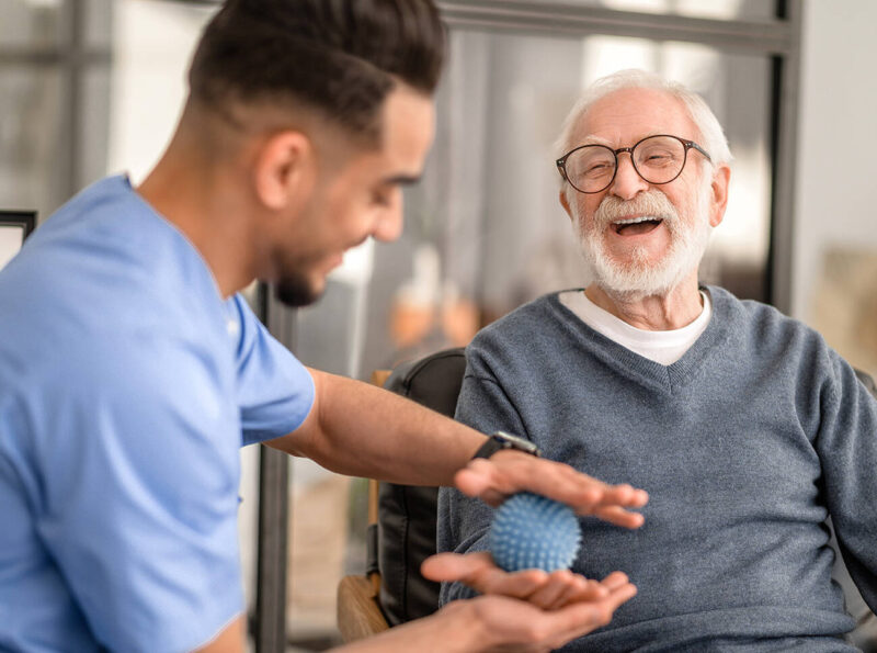 Male nurse helping elderly man