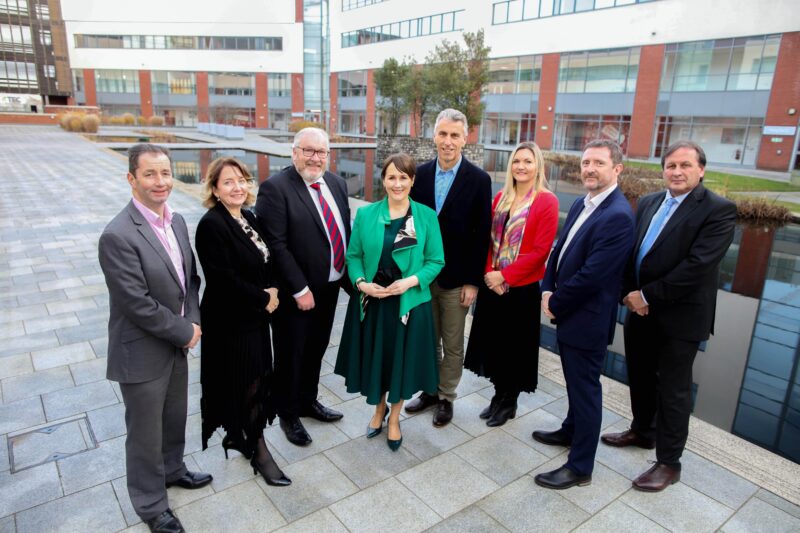 Group of eight people in a line outside a college in Belfast