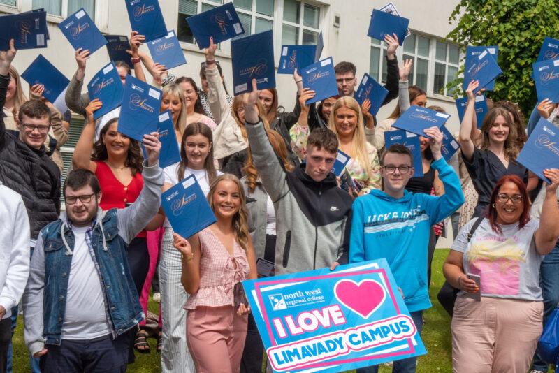 Large crowd outside a college building with a sign that says I Love Limavady campus