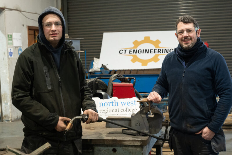 Two male welders in a factory