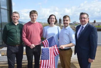 Five people with a US flag