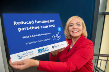 Businesswoman in  a red suit holds up a rectangular graphic for reduced funding for part time courses.