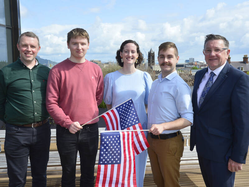 Five people with a US flag